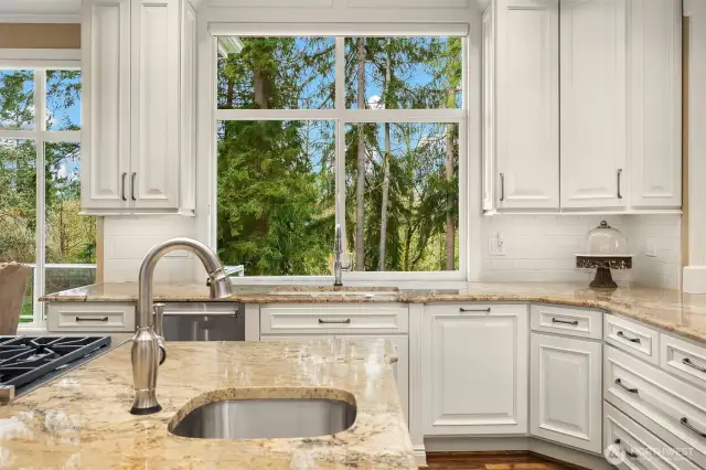 Gorgeous, spotless, expanded and remodeled Chef's kitchen ~ granite counters, huge island, eating bar, 6-burner Wolfe range, double ovens, SubZero fridge and abundant cabinet & counter space.
