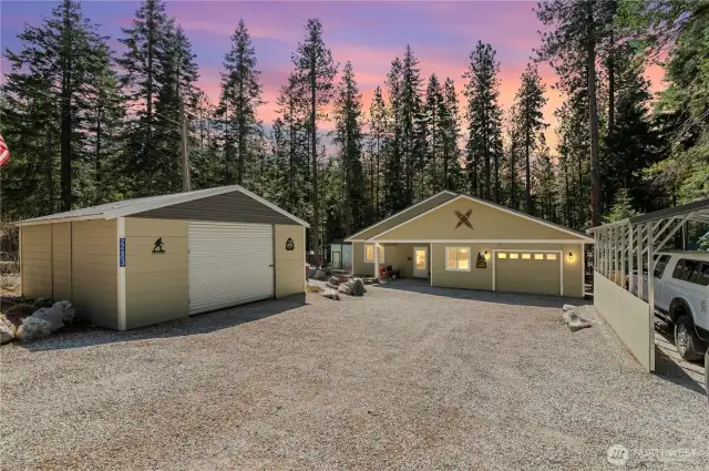 View of the enclosed carport that can fit 2 cars or several toys! Main house has attached one car garage with extra shop space!  Also included is additional carport for another car or more toys. Plenty of outside parking too!