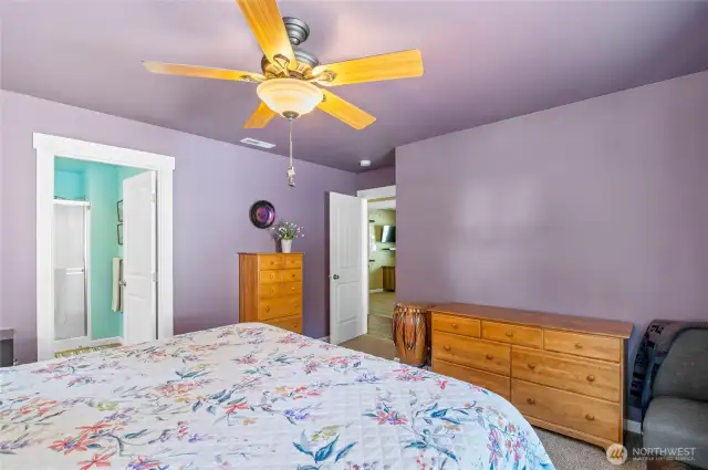 Primary bedroom w/ ceiling fan.