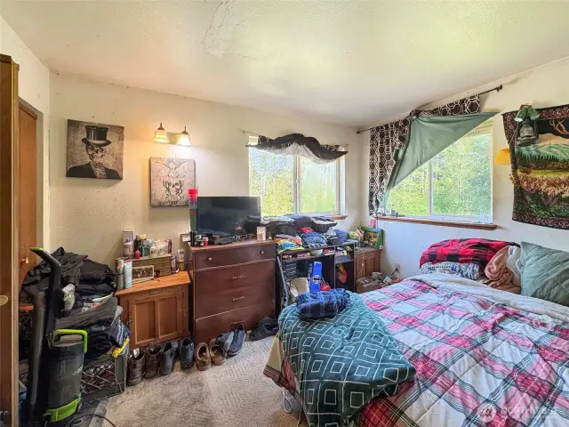 Upstairs bedroom with double closets to the left. King size bed.