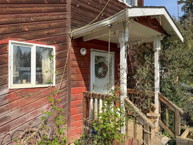 Front porch, kitchen window to the left.