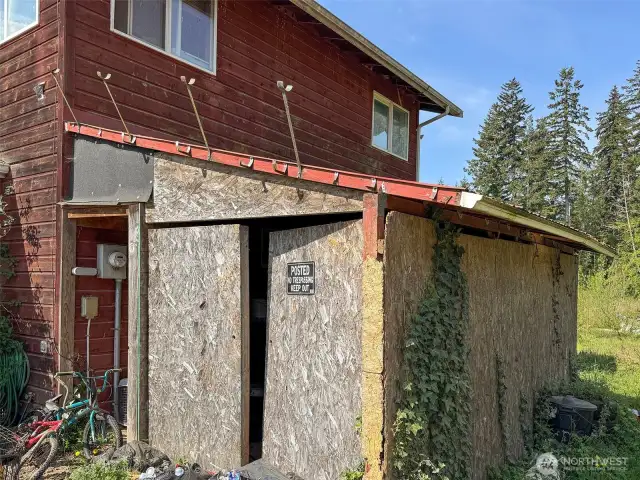 Enclosed carport, used for storage.