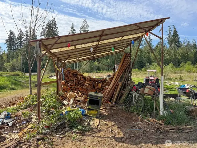 Open carport, presently being used as a wood shed. Wood to be removed before seller vacates the property.