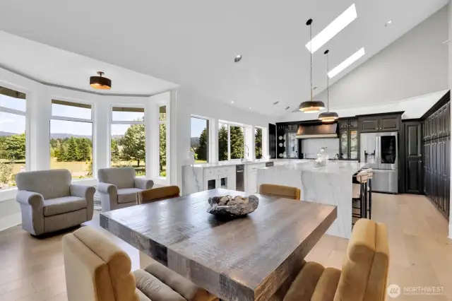 Dining room showing kitchen and bay window
