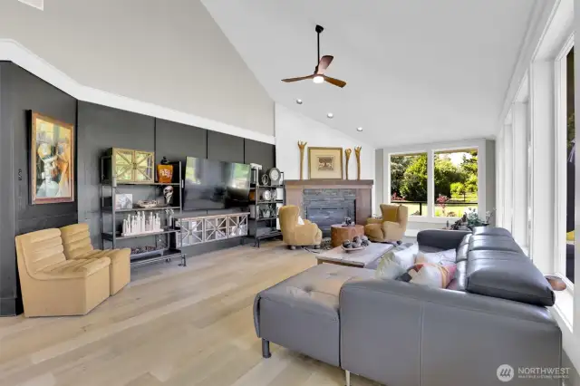 Family room with wall of windows and custom fireplace