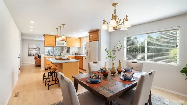 Open-concept kitchen and dining area filled with natural light.