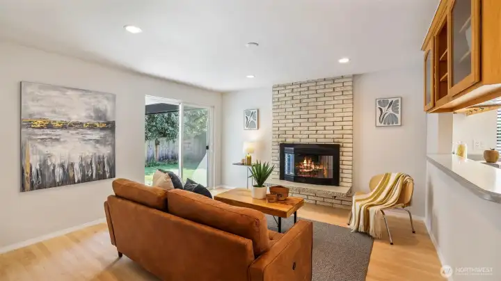 Relax by the fireplace in this bright and welcoming living area.