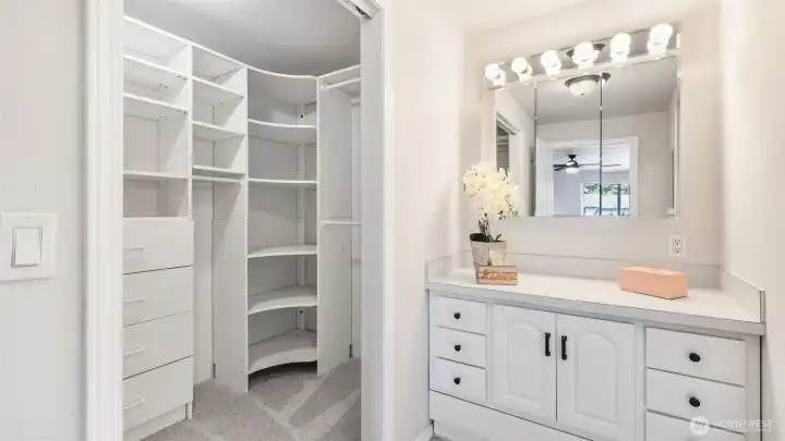 Walk-in closet with built-in shelving and drawers for effortless organization.