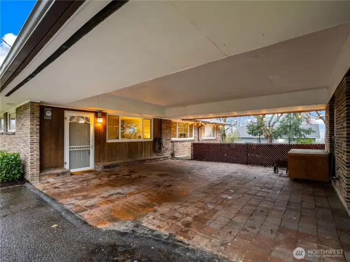 The covered carport has two large storage units at the right hand side.