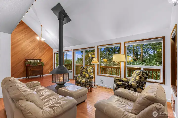 Open space living with windows that show sunsets