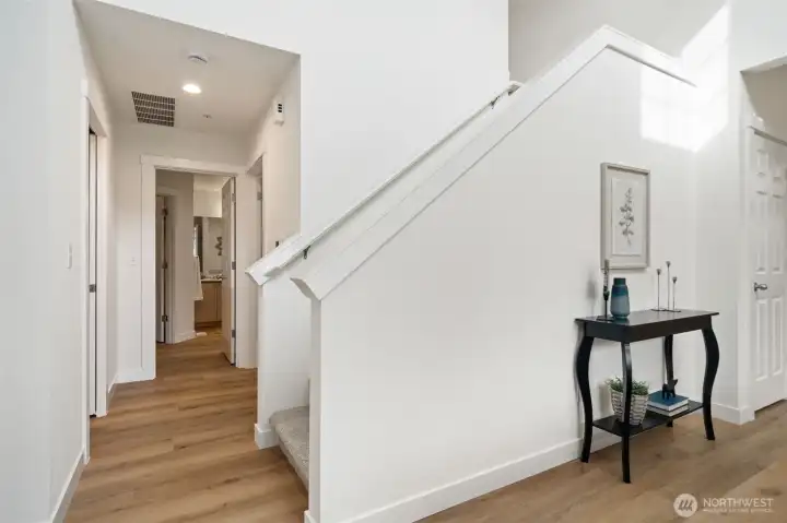 Hallway to main primary bedroom on main with 1/2 bath off hall - all new floors & paint.