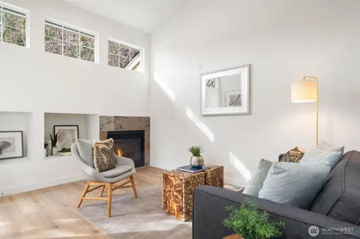 Recreation room with gas fireplace off kitchen with door to patio.