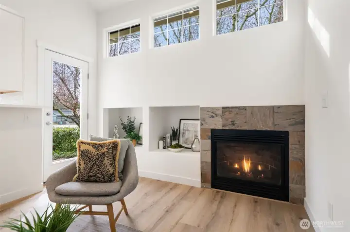 Tall clear story windows, gas fireplace, door to patio and right off kitchen.