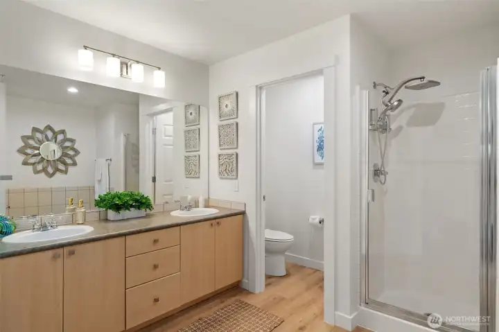 Nice double sinks with private toilet area in the primary suite - separate stall shower from bathtub.