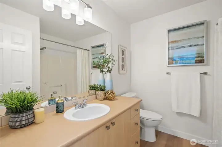 2nd level full hall bathroom with bathtub and new toilet.