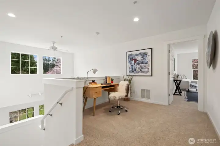 Upstairs hallway showing the high ceilings, ceiling fan and great windows.