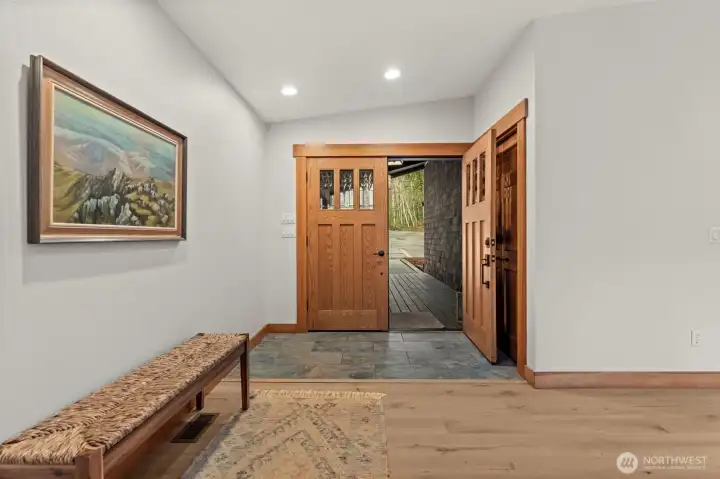 Clean entry with hardwood floors and natural light