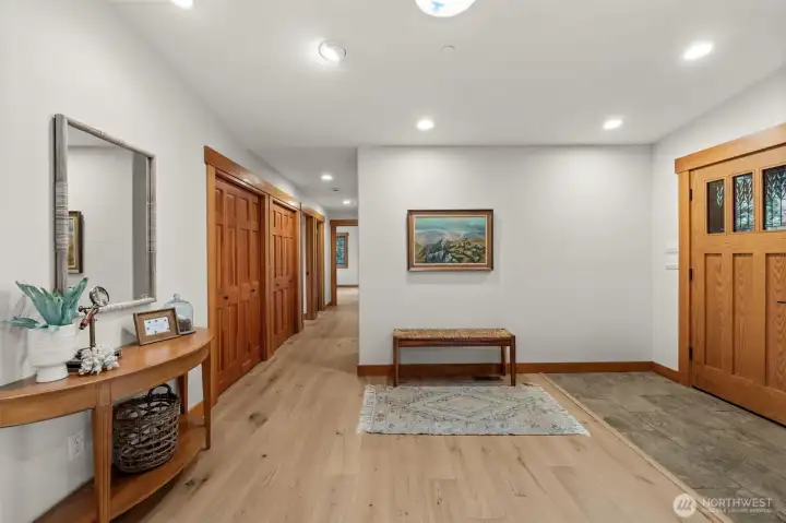 Spacious entry hallway with hardwood floors and built-in storage