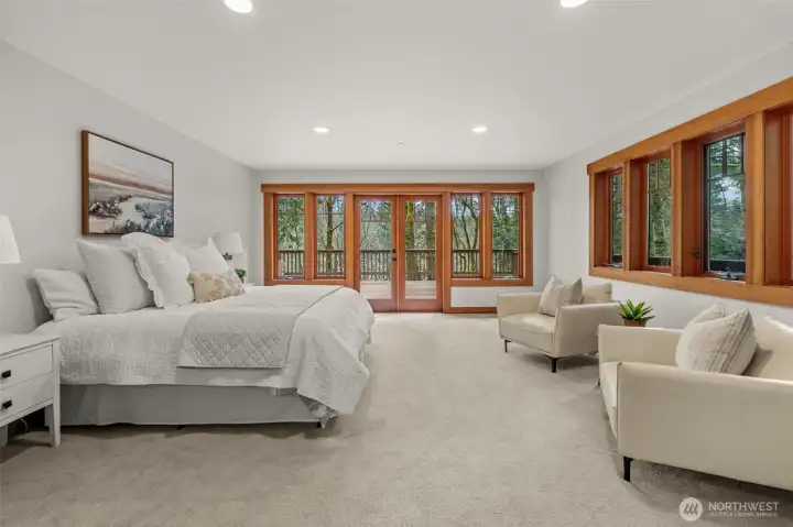 Primary suite with large windows and natural light