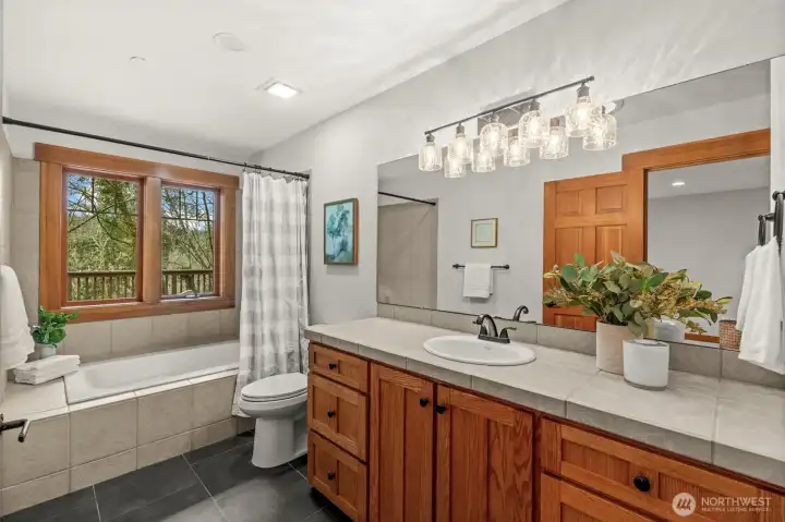 Bathroom with double vanity and full tub/shower combination