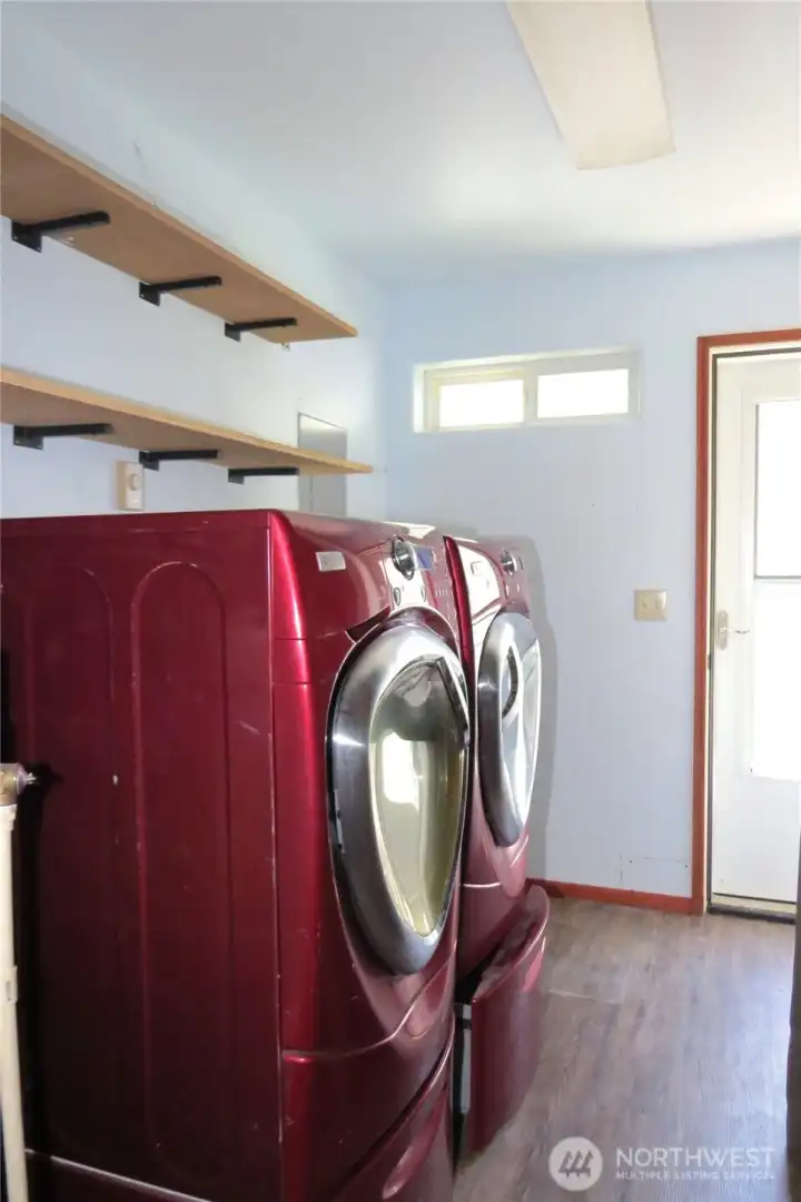 Down the hallway to the left is the laundry room continuing with the Luxury Vinyl plank flooring! On the opposite wall is plenty of storage!