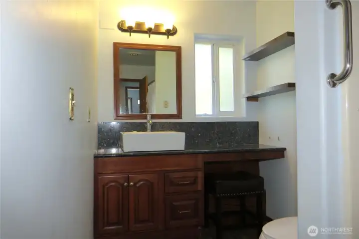 Bathroom contines with the shaker-style vanity and granite countertop!