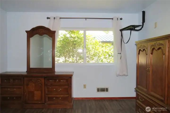 Primary bedroom continues with the large windows for natural lighting!