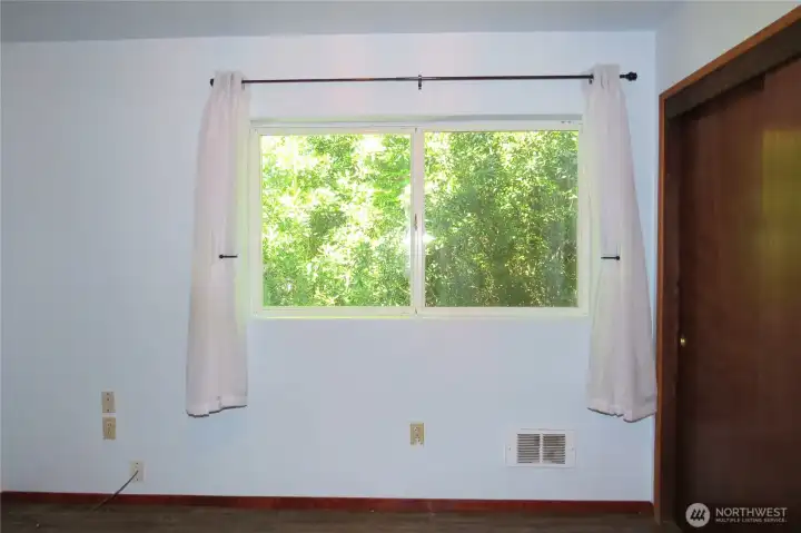 Entering the second bedroom with continued large windows for natural lighting!