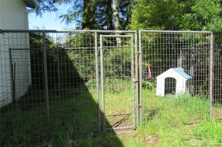 Just outside the laundry room entrance is a fenced kennel for the owner's best friend!