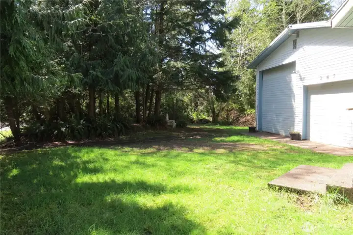 The home comes with an additional lot.  This view is from in front of the home toward the tree line on the other side!