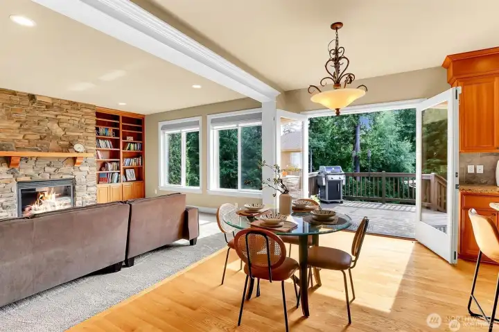 Family room off chef's kitchen with stone fireplace and built in book shelves.