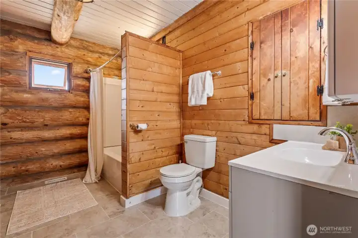 The main floor bathroom has been recently updated with new tub, vanity, toilet and beautiful tile floor