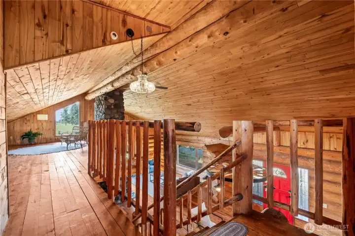 Stepping out of the primary bedroom leads to the loft