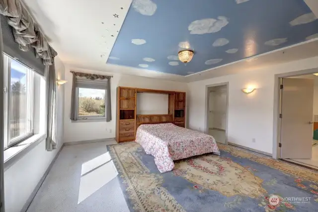 Primary suite overlooks the Ilwaco Airport with walk in closet and primary bath with walk in double headed shower. .
