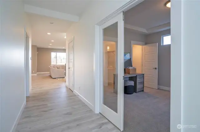 French doors open to a versatile den, office, or 5th bedroom with double closets.