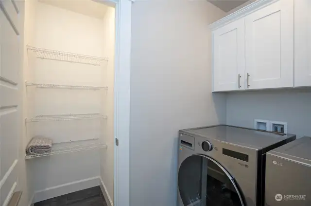 The upper-level utility room offers added convenience with extra cabinetry and a spacious closet for ample storage.