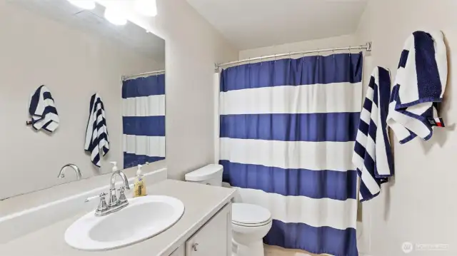 Guest-friendly full bathroom with a shower—offering both comfort and convenience for visitors.