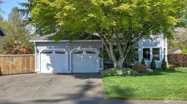 Spacious two-car garage and driveway provide ample room for parking, storage, and everyday convenience