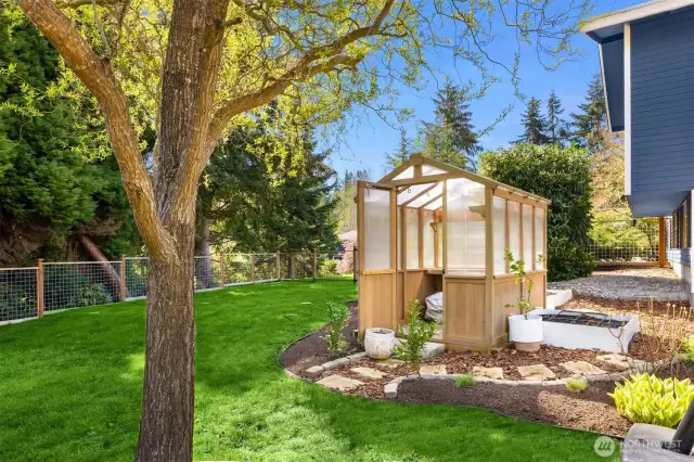 Gardener's paradise with green house and planter beds