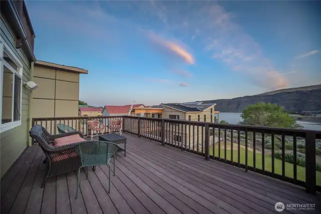 Expansive deck overlooking rear yard and cove