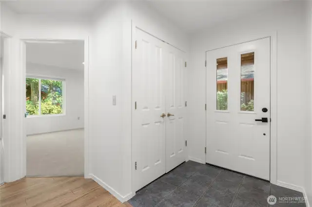 Tiled floor entry, guest closet are near two bedrooms.