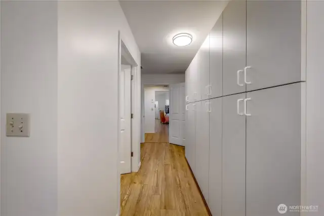 Utility room with tons of built in cabinet storage for pantry items or household items and tools. Half bath and laundry, hot water heater and radiant floor system also located in this room. Closes off from both kitchen and living areas to keep seperate.