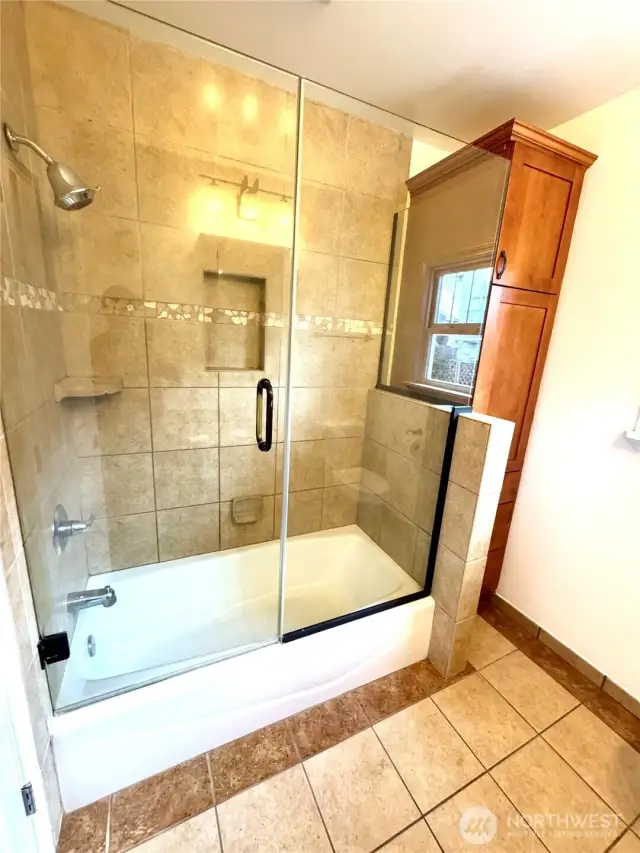 Custom tile work and thick shower door!