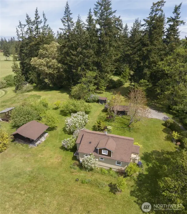 Beyond the main residence, this property boasts additional outbuildings, perfect for a studio, worship, or extra storage, all within your private estate.