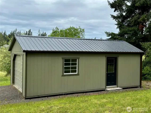 Extra garage/storage building blends in well to the surrounding woodlands.  A great place for extra equipment or even storage while you build a new project.
