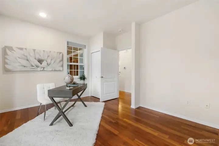 The third bedroom with lovely wood floors and storage under the bench and closet!
