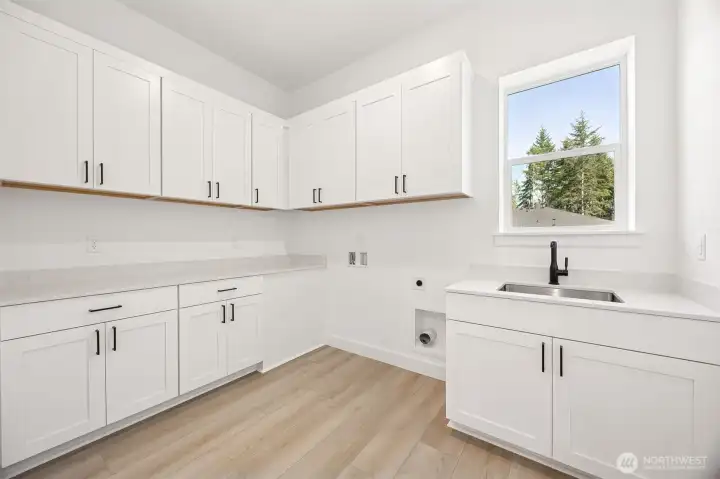 Laundry Room  Photos are of another home in the community- finishes will vary.