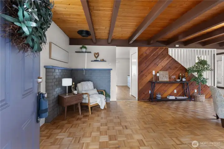 Spacious entryway with wood floors leads into the heart of the home.