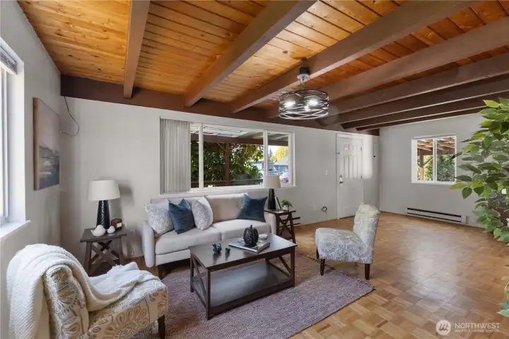 Open-concept living area seamlessly flows into dining and kitchen spaces.
