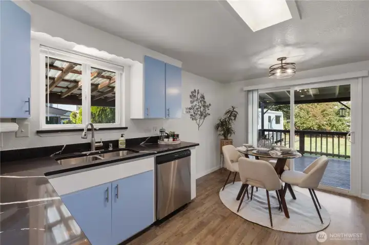 Beautifully designed kitchen with rich blue cabinetry, quartz countertops, and stainless steel appliances—where function meets style.